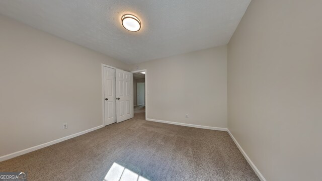 8256 Milam Loop, Fairburn, GA 30213 - unfurnished room featuring carpet floors, a textured ceiling, and baseboards