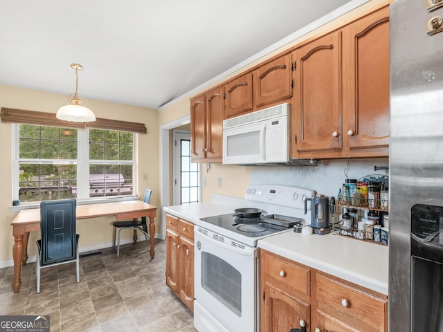 kitchen featuring white appliances, light countertops, brown cabinetry, baseboards, and pendant lighting