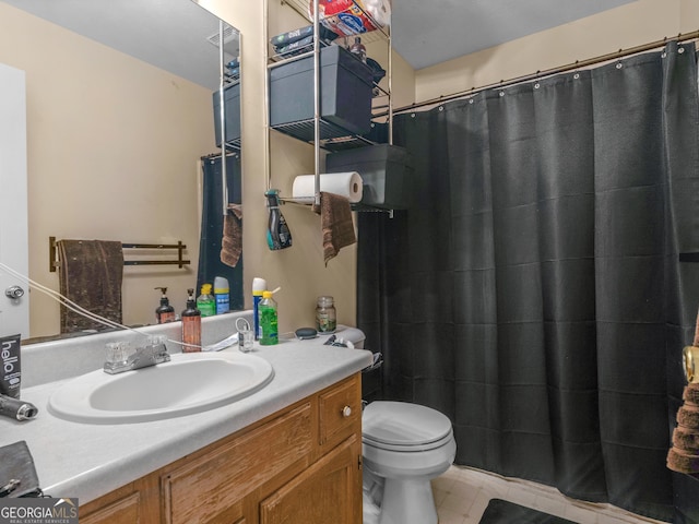 bathroom featuring vanity, toilet, and curtained shower