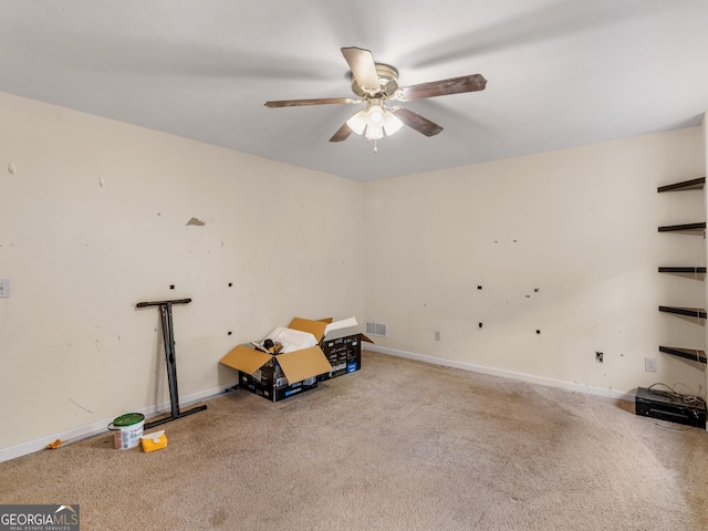 misc room with visible vents, carpet, ceiling fan, and baseboards