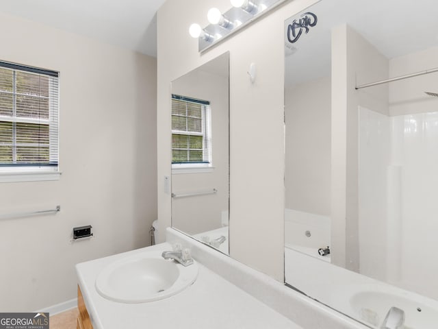 bathroom featuring plenty of natural light, toilet, and vanity