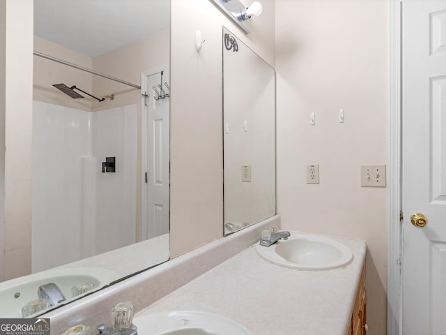 bathroom with double vanity, visible vents, and a sink