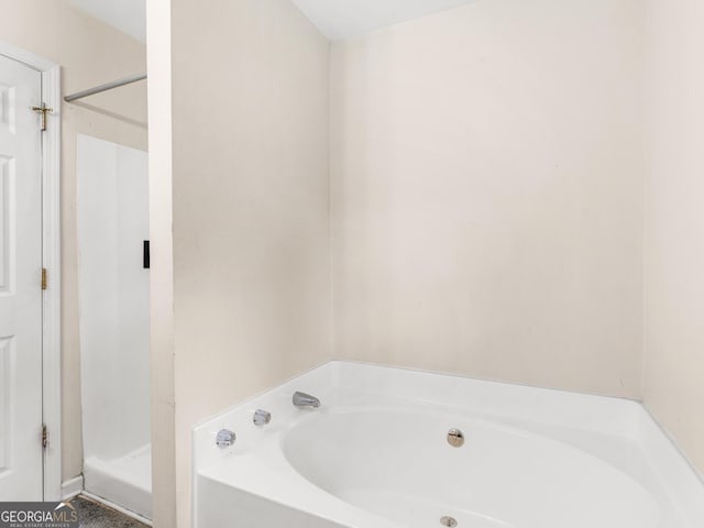 full bath featuring a shower stall and a bath