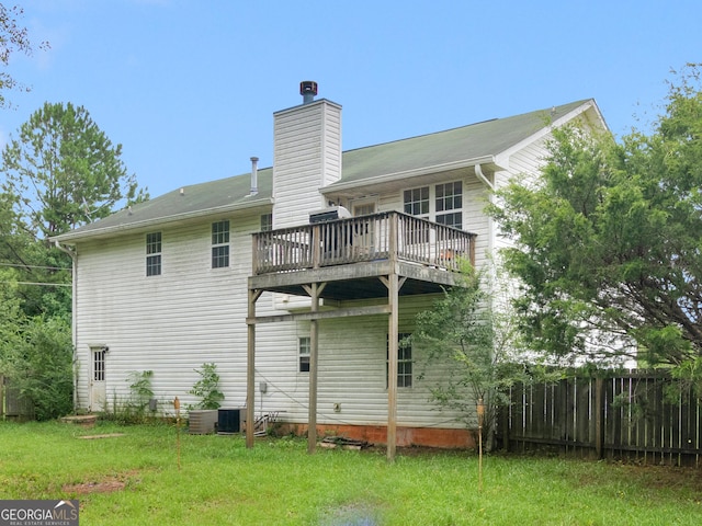 rear view of property featuring a yard, central AC, fence, and a chimney