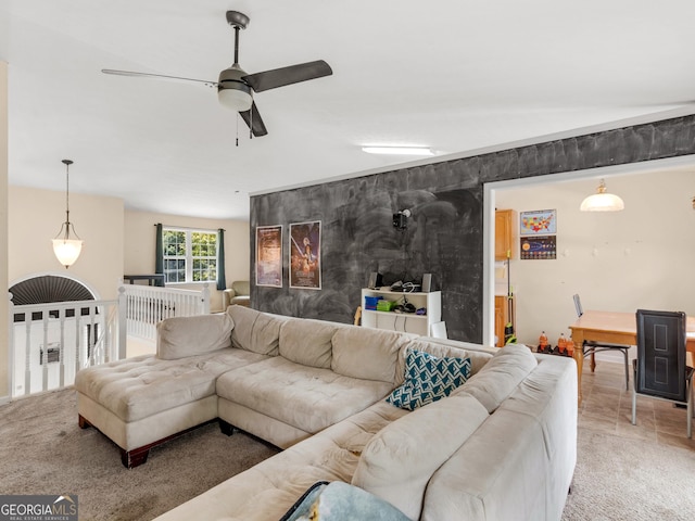 carpeted living room featuring ceiling fan