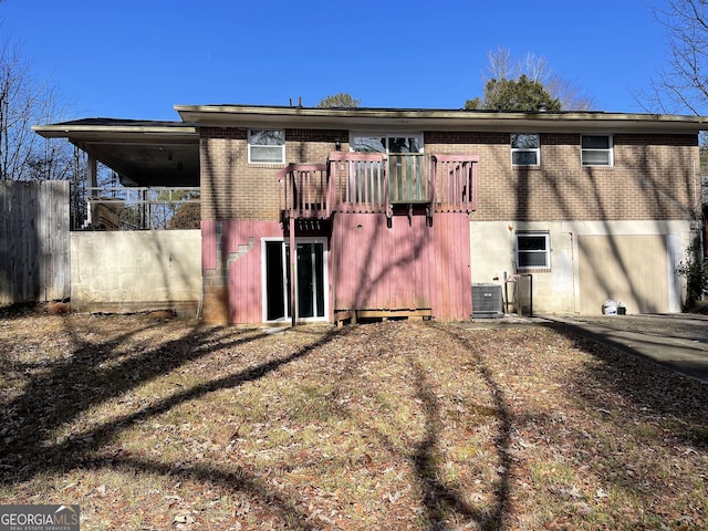 back of house with fence, cooling unit, and brick siding