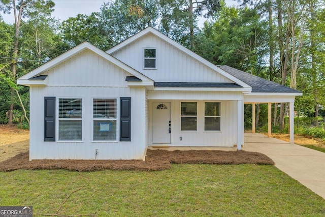 327 Peach Cir, Fort Valley, GA 31030 - view of front of house featuring roof with shingles, a front lawn, concrete driveway, and an attached carport