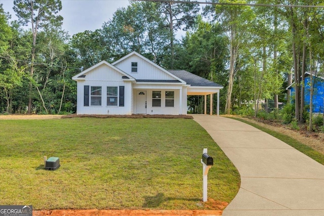 327 Peach Cir, Fort Valley, GA 31030 - modern inspired farmhouse featuring concrete driveway, an attached carport, and a front yard