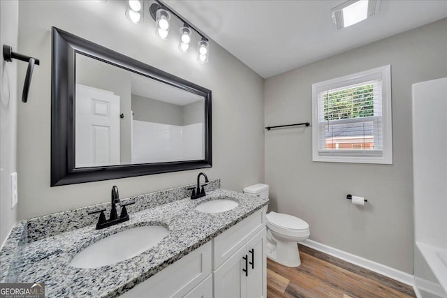 327 Peach Cir, Fort Valley, GA 31030 - bathroom featuring wood finished floors, double vanity, a shower, and a bath