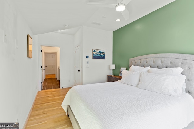 686 Exchange St SE, Atlanta, GA 30315 - bedroom with light wood-style floors, baseboards, ceiling fan, and vaulted ceiling