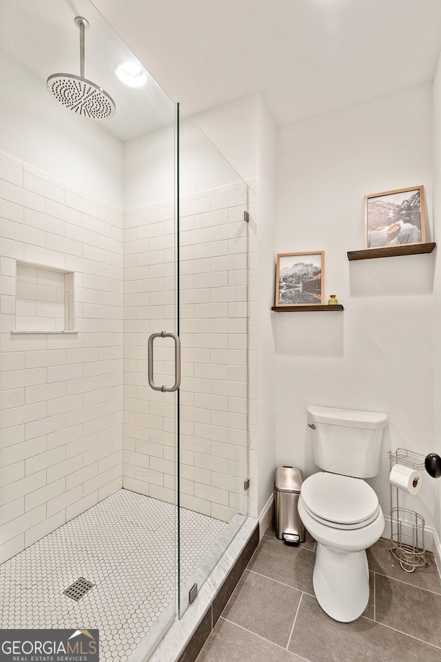686 Exchange St SE, Atlanta, GA 30315 - full bathroom featuring toilet, tile patterned floors, a shower stall, and baseboards