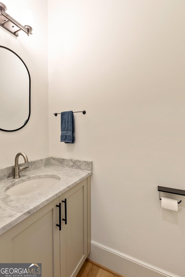 686 Exchange St SE, Atlanta, GA 30315 - bathroom with baseboards, wood finished floors, and vanity