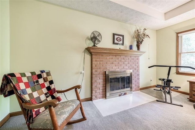 living area featuring carpet floors, a textured ceiling, baseboards, and a fireplace