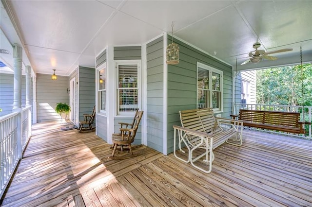 wooden deck featuring ceiling fan and covered porch