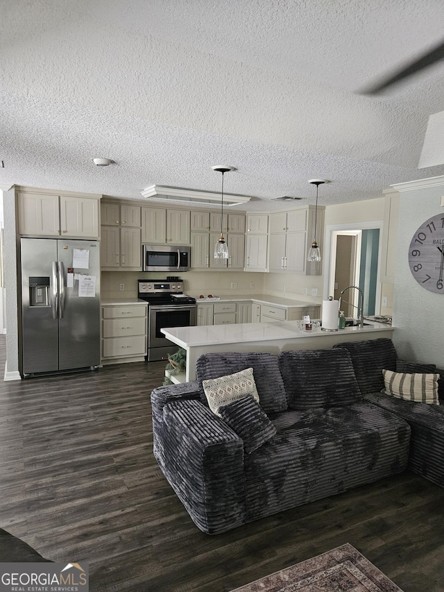 living room with a textured ceiling and dark wood finished floors