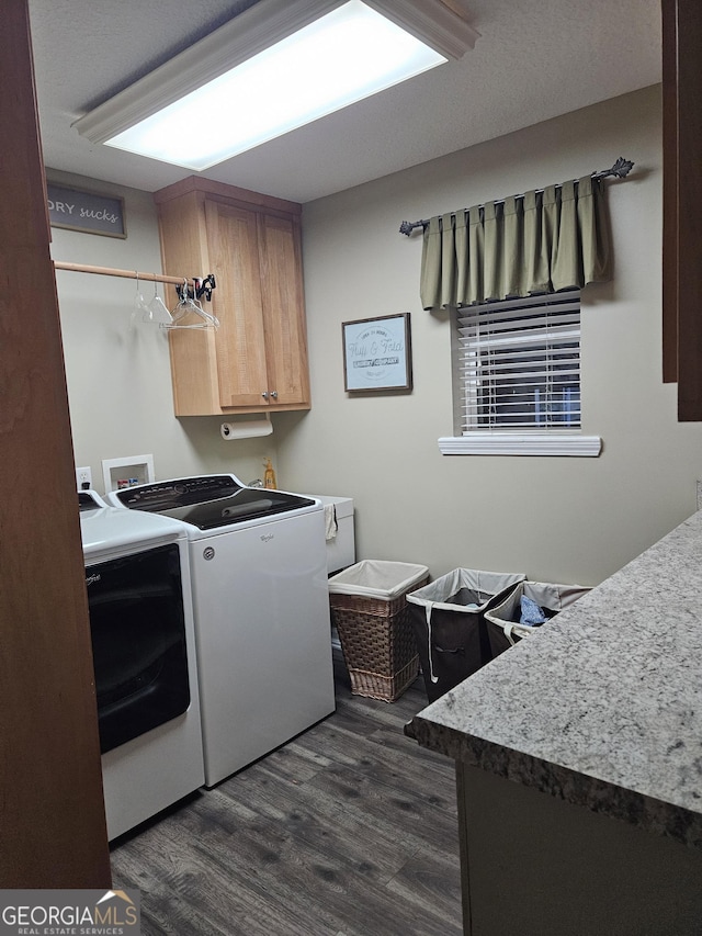 laundry room with washing machine and dryer, cabinet space, and dark wood-type flooring