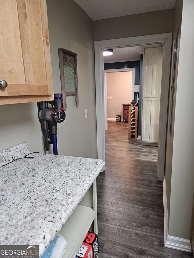 interior space featuring baseboards and dark wood finished floors