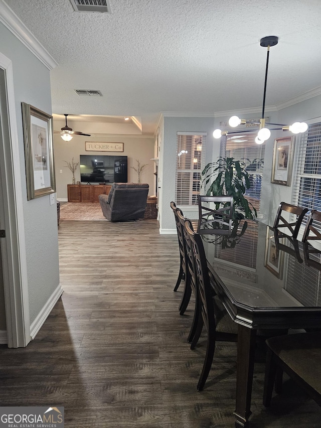 dining room featuring visible vents, ornamental molding, dark wood-style flooring, and baseboards