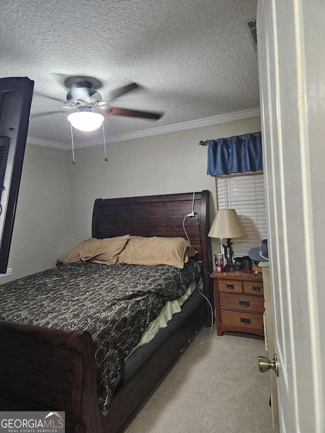 carpeted bedroom featuring visible vents, ornamental molding, a textured ceiling, and ceiling fan