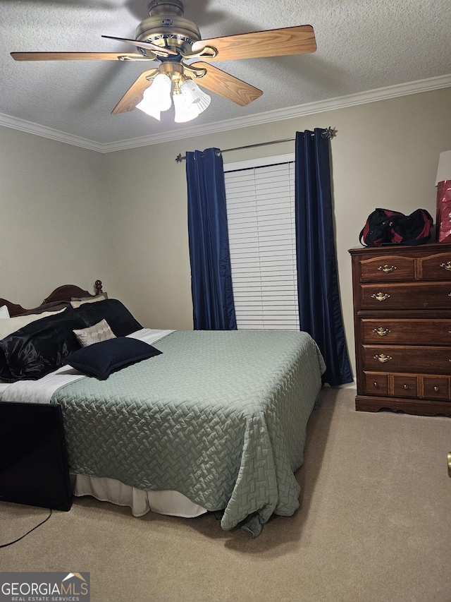 carpeted bedroom with a ceiling fan, a textured ceiling, and ornamental molding