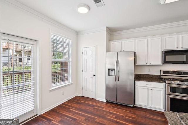 3505 Chattahoochee Summit Ln SE Unit 25, Atlanta, GA 30339 - kitchen featuring stainless steel appliances, ornamental molding, white cabinetry, dark wood-style flooring, and dark stone countertops