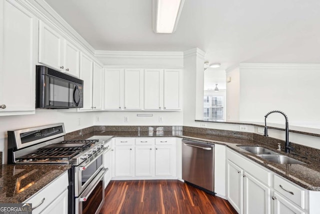 3505 Chattahoochee Summit Ln SE Unit 25, Atlanta, GA 30339 - kitchen featuring appliances with stainless steel finishes, white cabinets, dark stone countertops, dark wood-style floors, and a peninsula