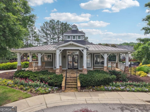 3505 Chattahoochee Summit Ln SE Unit 25, Atlanta, GA 30339 - view of front of property featuring french doors, a standing seam roof, covered porch, a metal roof, and stairway