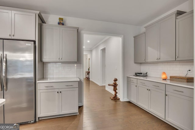 463 Marston Pass, Acworth, GA 30102 - kitchen with freestanding refrigerator, baseboards, gray cabinetry, and tasteful backsplash