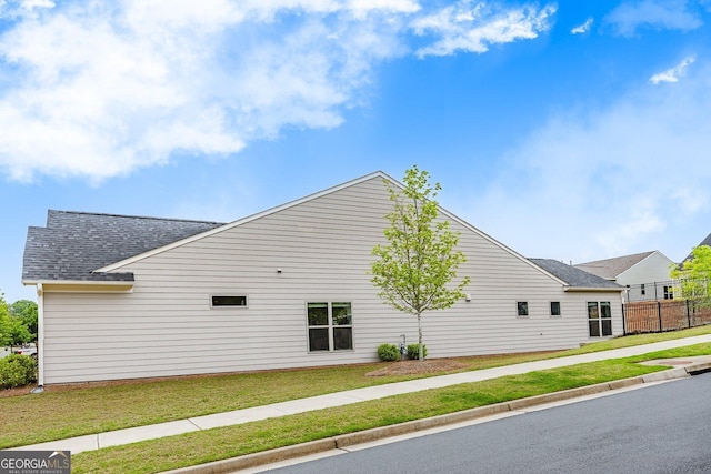 463 Marston Pass, Acworth, GA 30102 - view of home's exterior featuring a lawn, a shingled roof, and fence