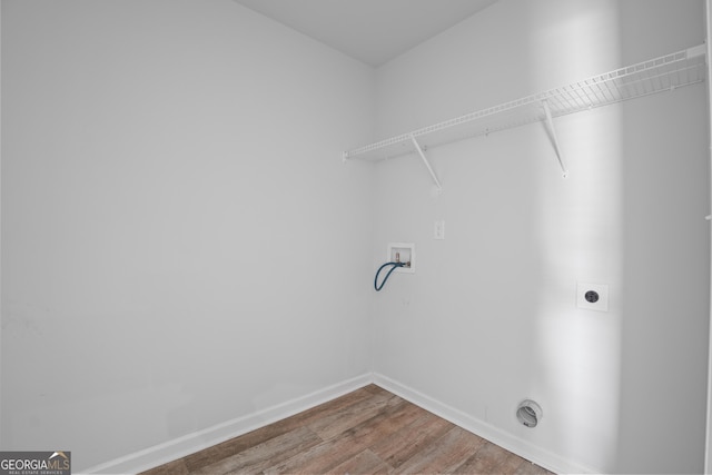 laundry room with hookup for an electric dryer, laundry area, wood finished floors, baseboards, and hookup for a washing machine