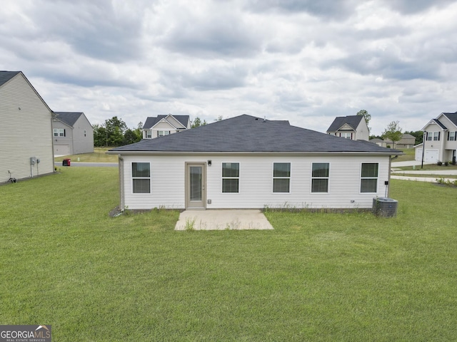back of property featuring a patio and a lawn
