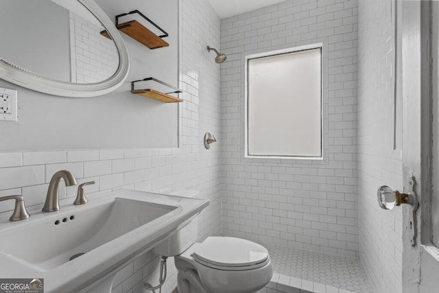 960 Byron Dr SW, Atlanta, GA 30310 - bathroom featuring a sink, tile walls, a tile shower, and toilet