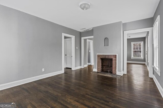 960 Byron Dr SW, Atlanta, GA 30310 - unfurnished living room featuring baseboards, a fireplace, and dark wood-type flooring