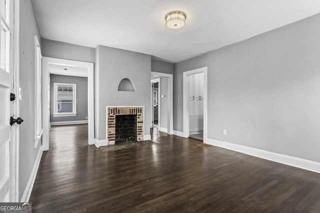 960 Byron Dr SW, Atlanta, GA 30310 - unfurnished living room featuring baseboards, a brick fireplace, and wood finished floors