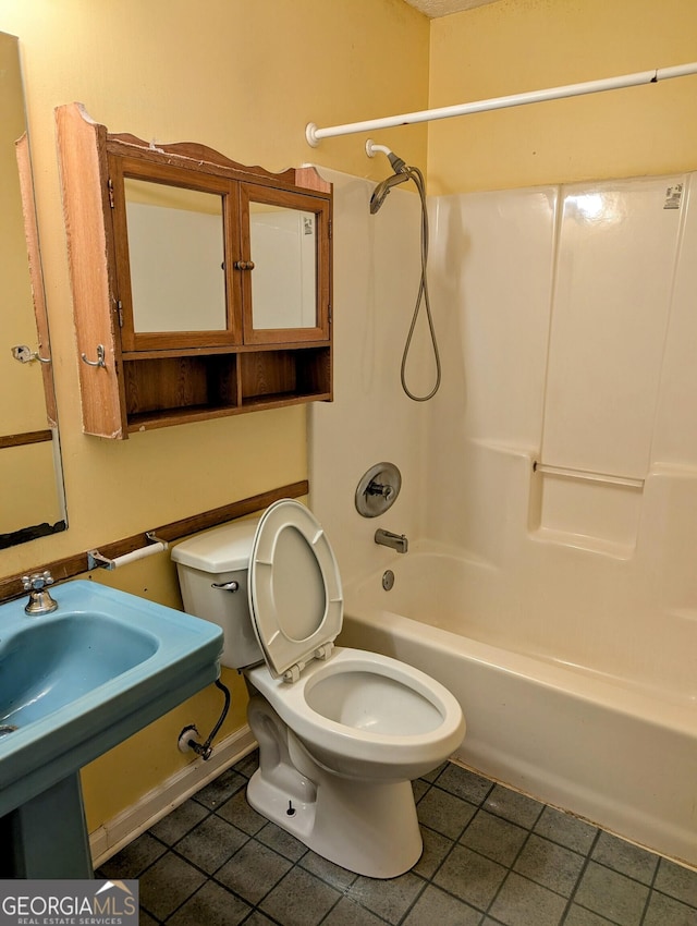 bathroom with shower / bathtub combination, tile patterned floors, and toilet
