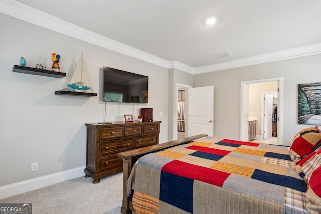 bedroom with ornamental molding, light colored carpet, baseboards, freestanding refrigerator, and ensuite bath