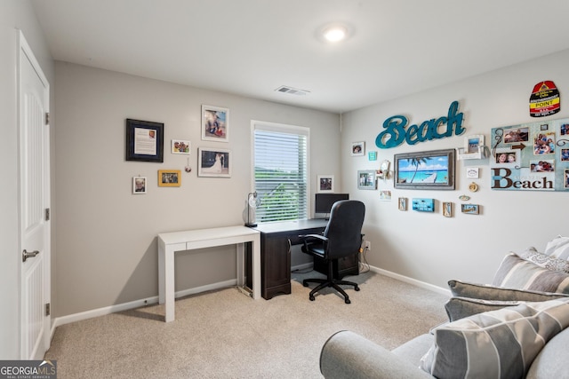office area featuring light carpet and baseboards