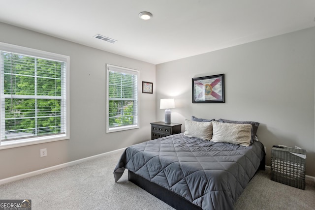 carpeted bedroom featuring baseboards