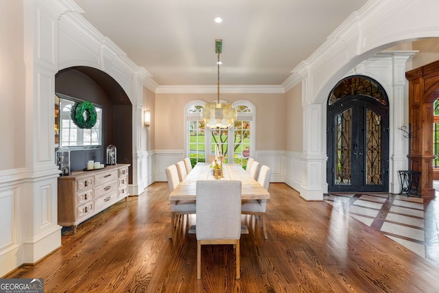 2855 Drayton Hall Dr, Buford, GA 30519 - dining space with an inviting chandelier, a wealth of natural light, wood finished floors, and arched walkways