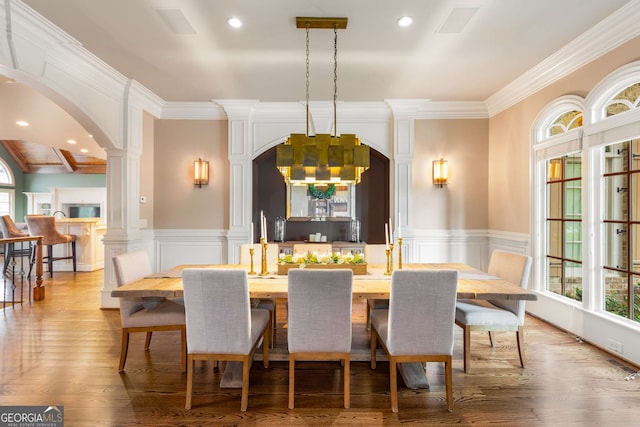 2855 Drayton Hall Dr, Buford, GA 30519 - dining room with ornamental molding, a notable chandelier, arched walkways, and plenty of natural light