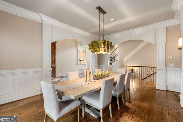2855 Drayton Hall Dr, Buford, GA 30519 - dining room with wood finished floors, wainscoting, arched walkways, and a notable chandelier
