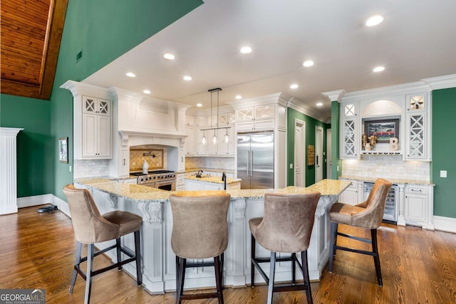 2855 Drayton Hall Dr, Buford, GA 30519 - kitchen with light stone counters, custom exhaust hood, decorative backsplash, beverage cooler, and high end appliances