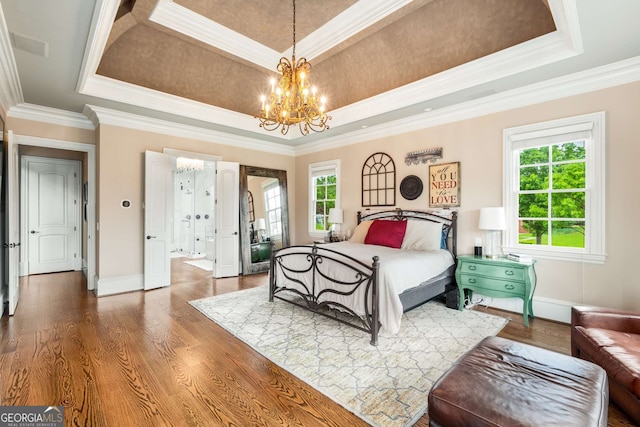 2855 Drayton Hall Dr, Buford, GA 30519 - bedroom featuring a chandelier, a raised ceiling, crown molding, and wood finished floors