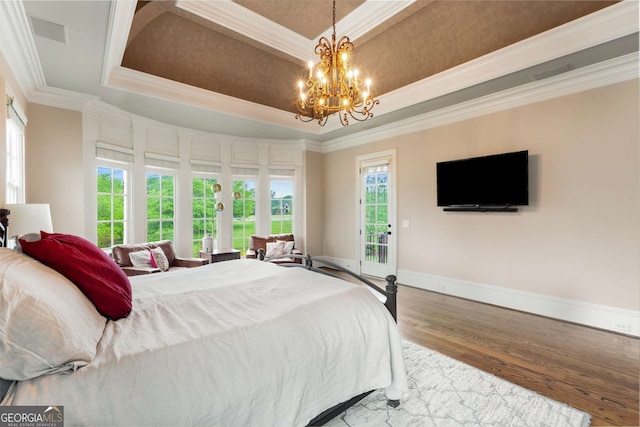 2855 Drayton Hall Dr, Buford, GA 30519 - bedroom with crown molding, a raised ceiling, wood finished floors, and access to exterior
