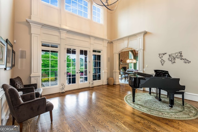 2855 Drayton Hall Dr, Buford, GA 30519 - sitting room with a high ceiling, a notable chandelier, ornate columns, and wood finished floors