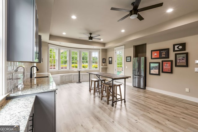 2855 Drayton Hall Dr, Buford, GA 30519 - kitchen with a sink, freestanding refrigerator, recessed lighting, ceiling fan, and light wood-style floors