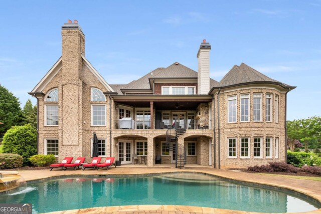 2855 Drayton Hall Dr, Buford, GA 30519 - back of house featuring a balcony, a chimney, a patio, and french doors