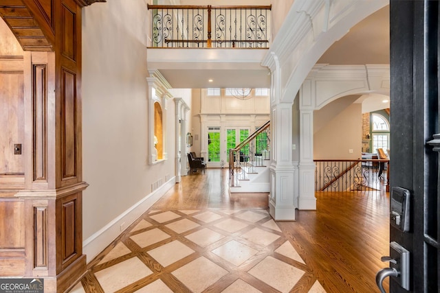 2855 Drayton Hall Dr, Buford, GA 30519 - foyer featuring plenty of natural light, baseboards, a towering ceiling, and arched walkways