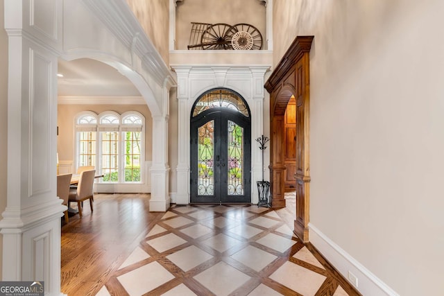 2855 Drayton Hall Dr, Buford, GA 30519 - foyer with french doors, ornamental molding, decorative columns, arched walkways, and a high ceiling
