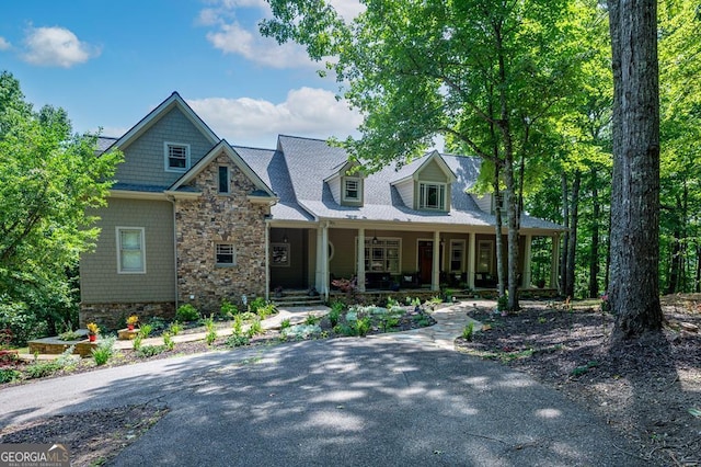 view of front facade featuring a porch and stone siding